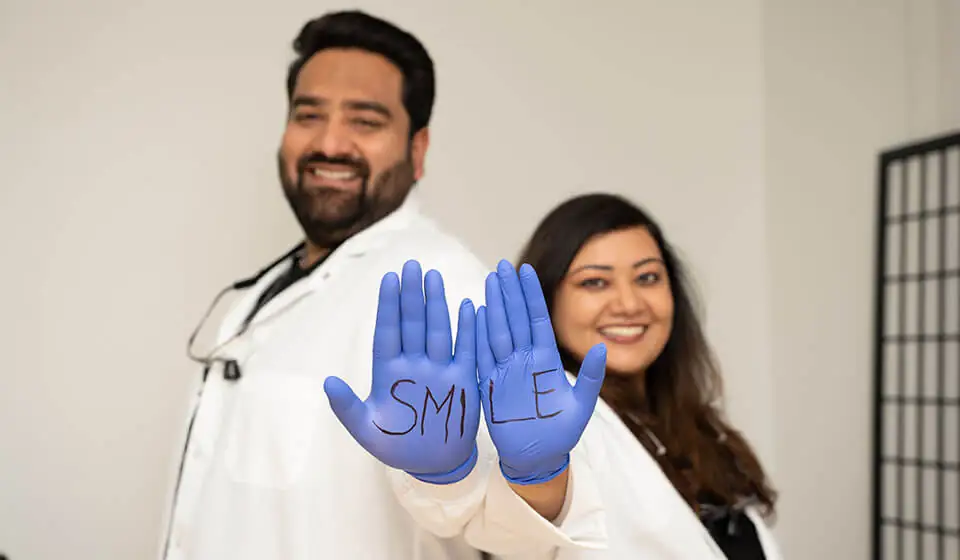 in house financing Issaquah, WA - Photo of Dr. Nitin Jaggi and Dr. Mannat Dhillon standing together.